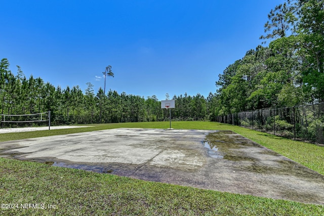 view of sport court featuring a yard and volleyball court