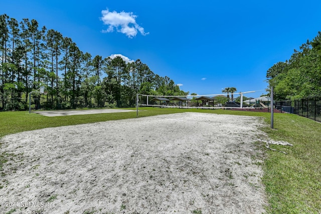 surrounding community featuring a yard and volleyball court