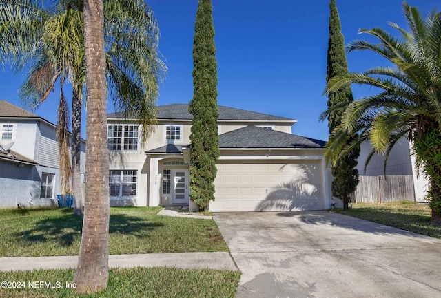 view of front of house featuring a garage and a front lawn