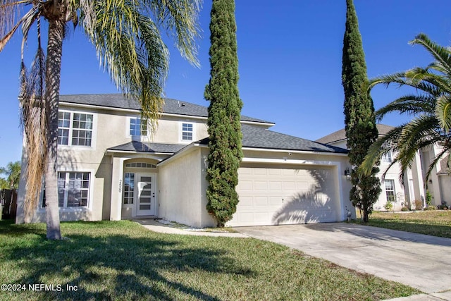 view of front of house featuring a front lawn and a garage