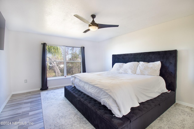 bedroom with ceiling fan and hardwood / wood-style flooring