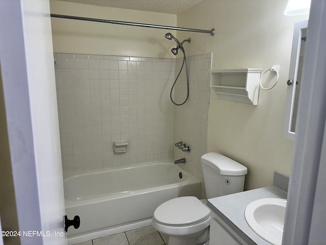 full bathroom featuring tile patterned floors, vanity, tiled shower / bath, and toilet