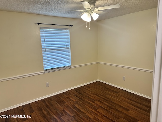 unfurnished room featuring ceiling fan, dark wood-type flooring, and a textured ceiling