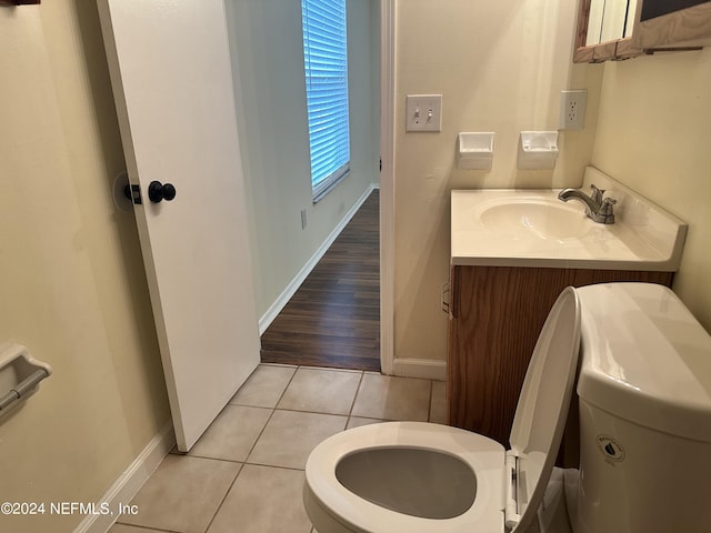 bathroom featuring tile patterned flooring, vanity, and toilet