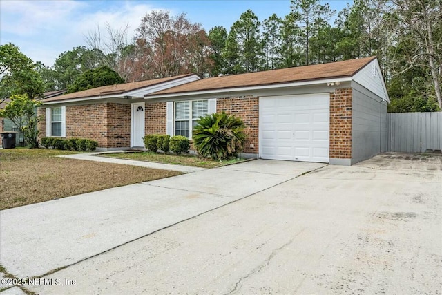 ranch-style house featuring a garage and a front lawn