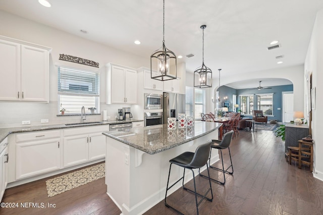 kitchen featuring a healthy amount of sunlight, sink, and dark hardwood / wood-style floors