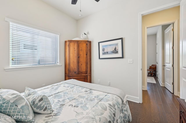 bedroom with dark hardwood / wood-style flooring and ceiling fan