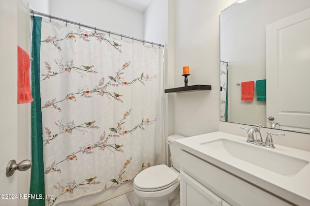 bathroom featuring vanity, toilet, and tile patterned floors