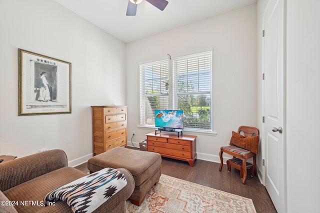 living area featuring ceiling fan and dark hardwood / wood-style flooring