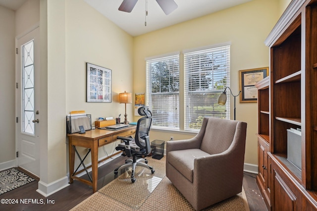 home office featuring dark wood-type flooring and ceiling fan