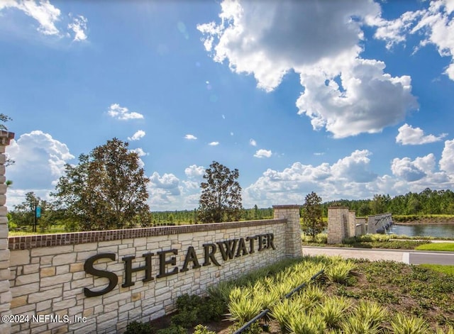 community sign featuring a water view