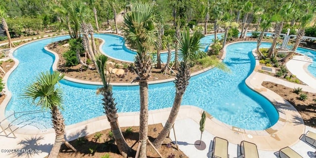 view of pool with a jacuzzi and a patio area