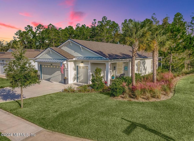 ranch-style house featuring a lawn and a garage