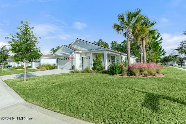 view of front of property featuring a garage and a front lawn