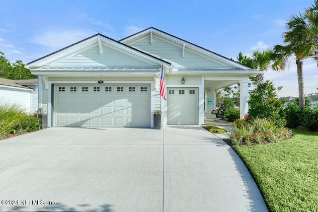 view of front of home with a garage and a front lawn