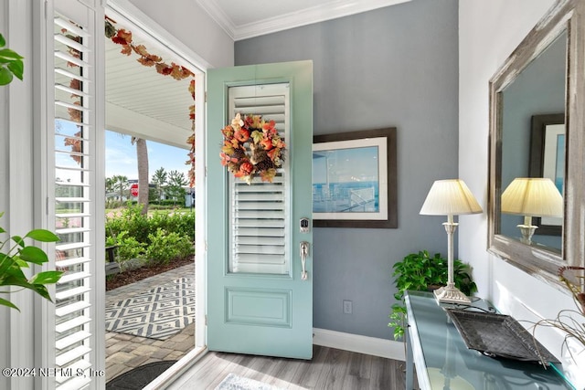 entryway with light hardwood / wood-style floors and ornamental molding