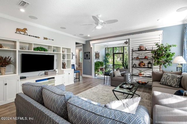 living room featuring ceiling fan, ornamental molding, and dark hardwood / wood-style floors