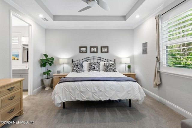 bedroom with light carpet, crown molding, ensuite bathroom, and ceiling fan