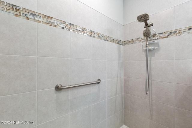 bathroom with tiled shower