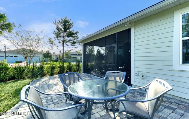 view of patio featuring a sunroom