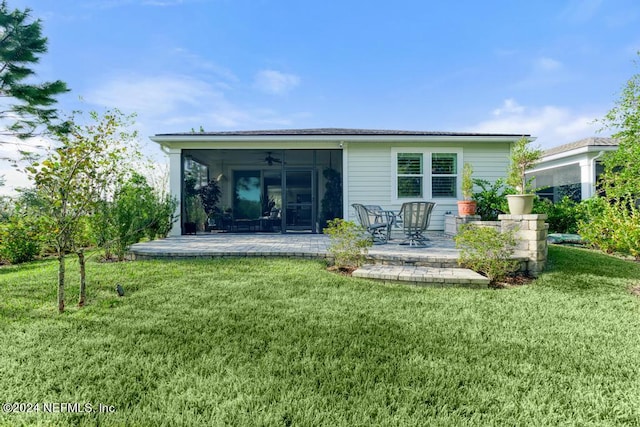 rear view of property with a patio, a yard, and ceiling fan