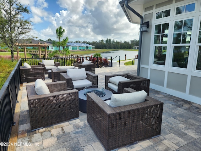 view of patio / terrace with outdoor lounge area and a water view