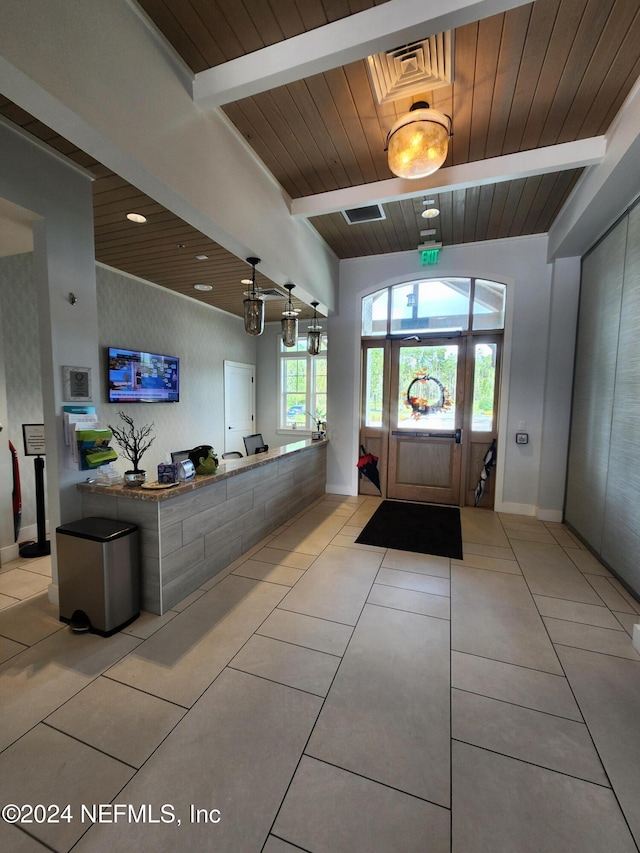 tiled foyer featuring lofted ceiling with beams and wooden ceiling