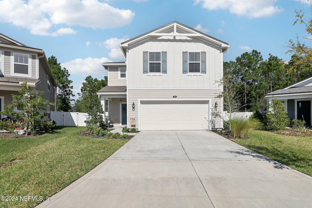 view of front of property featuring a garage and a front lawn