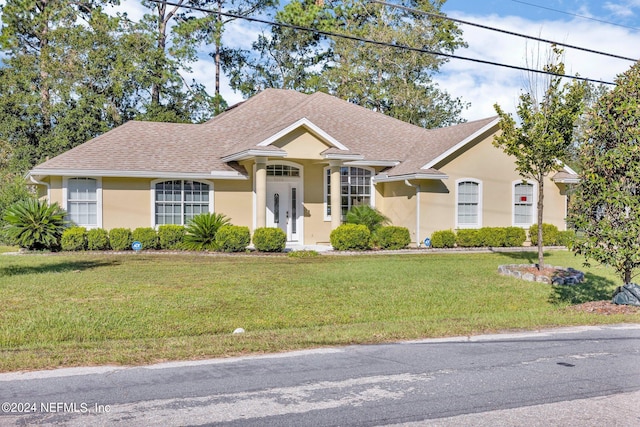 single story home featuring a front yard