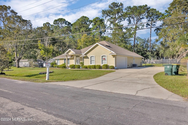 single story home featuring a front yard, a garage, and central AC unit