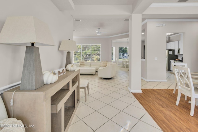 living room with ornamental molding and light wood-type flooring