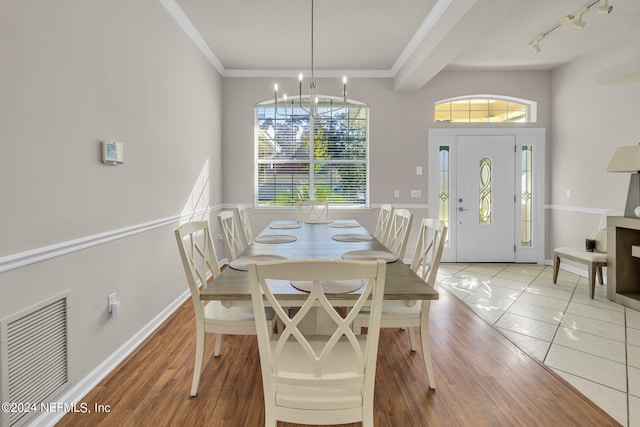 dining room with crown molding, a notable chandelier, and tile patterned floors