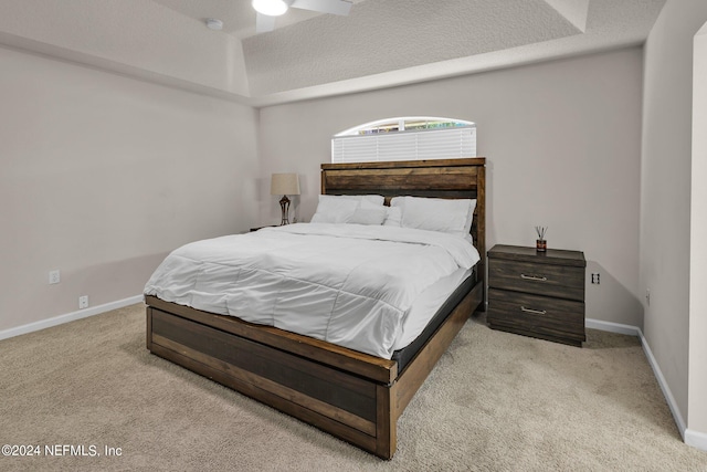 carpeted bedroom with a textured ceiling and ceiling fan