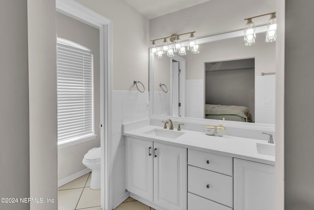 bathroom featuring vanity, toilet, and tile patterned floors