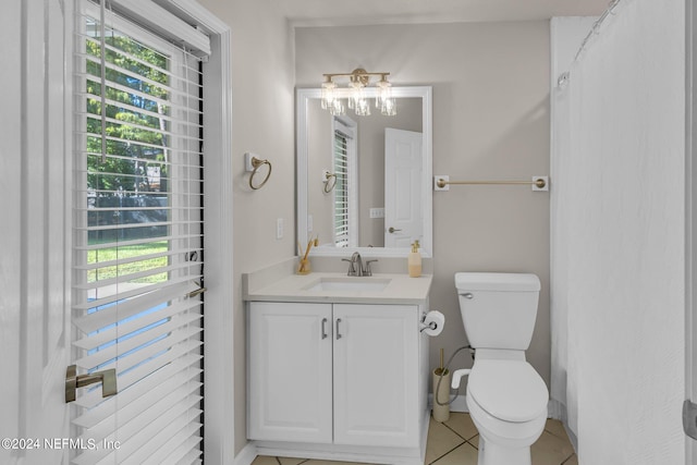 bathroom featuring toilet, vanity, and tile patterned flooring