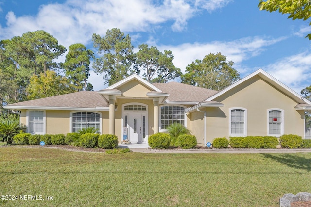 single story home with a front yard and french doors