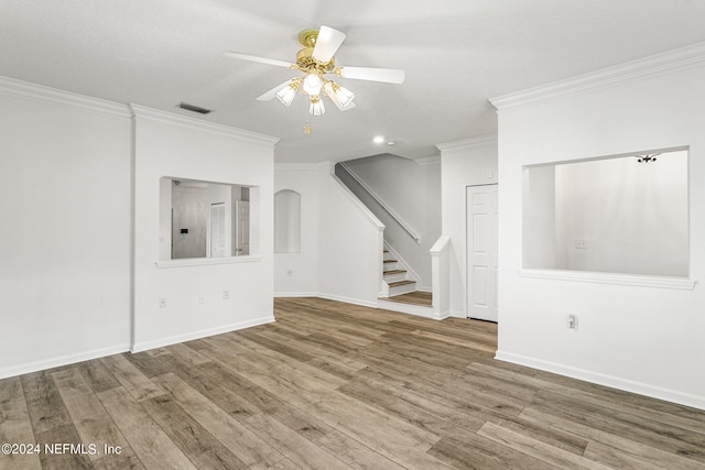 unfurnished living room with ceiling fan, crown molding, wood-type flooring, and a textured ceiling