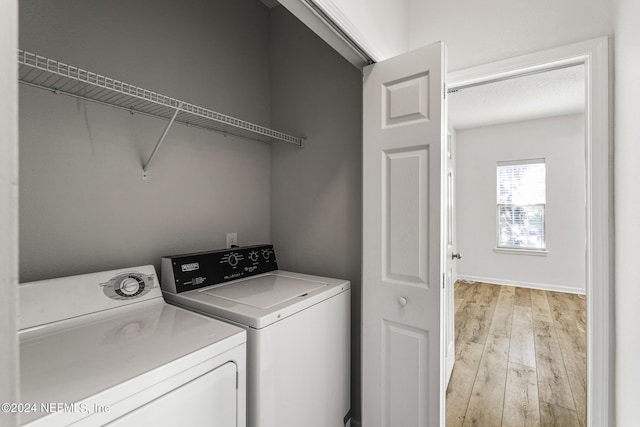 laundry room featuring light hardwood / wood-style flooring and independent washer and dryer