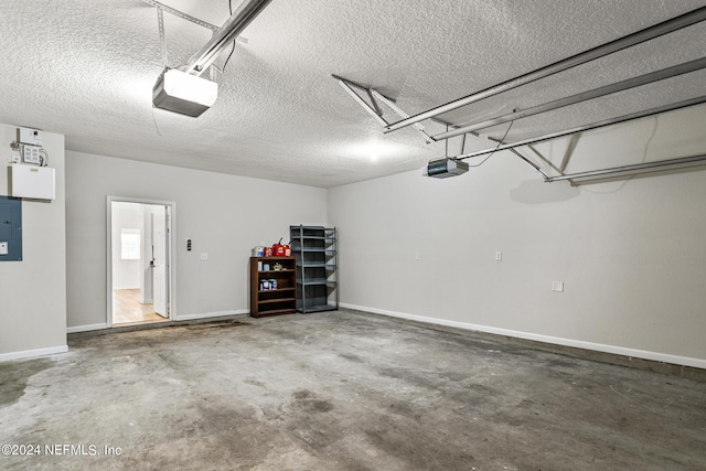 garage with a garage door opener and electric panel