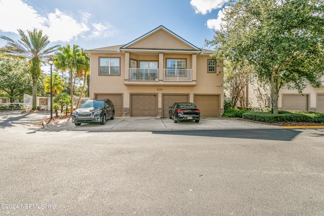 view of front of house with a balcony and a garage