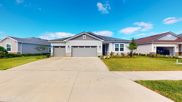 view of front of property with a front yard and a garage