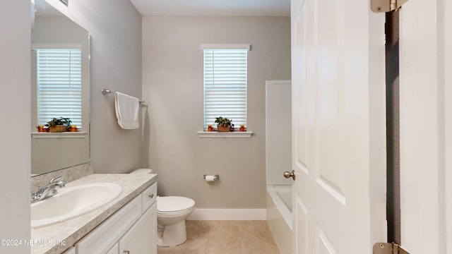 bathroom with toilet, vanity, tile patterned floors, and plenty of natural light