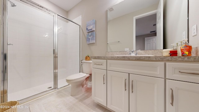 bathroom with vanity, toilet, and an enclosed shower