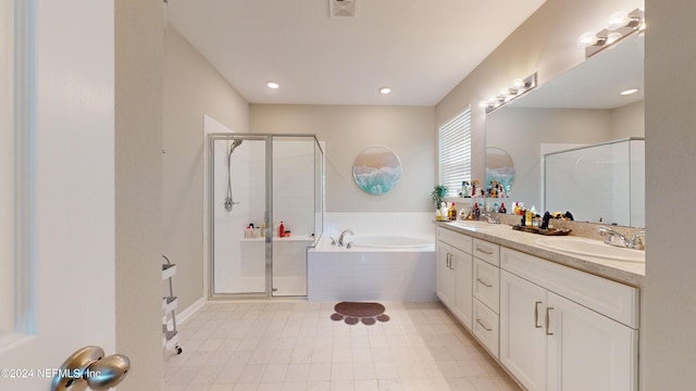 bathroom featuring vanity and plus walk in shower