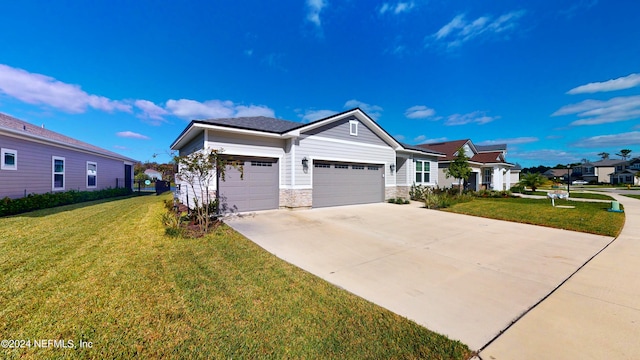 view of front of house with a front yard and a garage