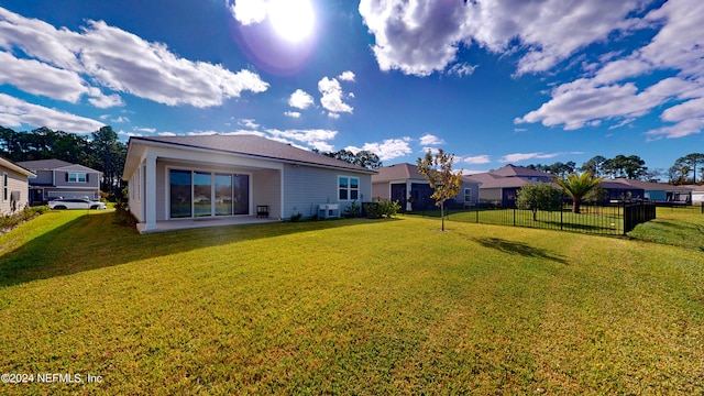 back of house featuring a yard