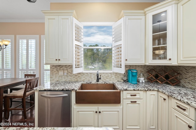 kitchen with ornamental molding, sink, light stone countertops, stainless steel dishwasher, and dark hardwood / wood-style flooring