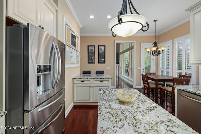 kitchen featuring dark hardwood / wood-style floors, stainless steel appliances, ornamental molding, light stone countertops, and a textured ceiling