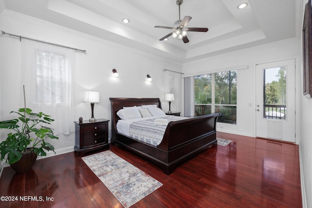 bedroom featuring ceiling fan, a raised ceiling, access to outside, and dark hardwood / wood-style flooring