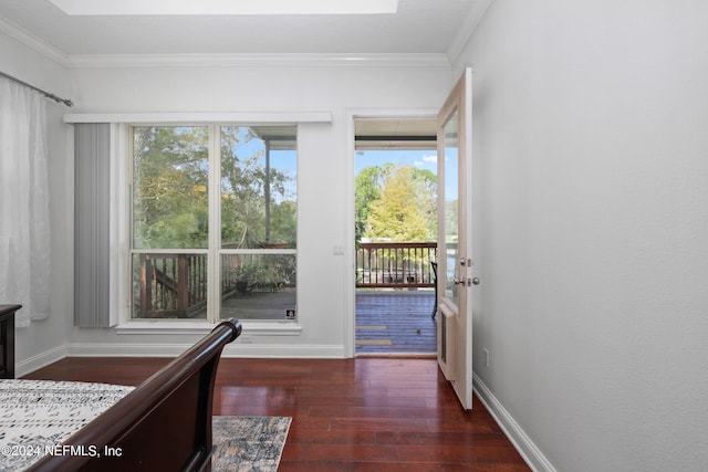 bedroom with ornamental molding and dark hardwood / wood-style floors